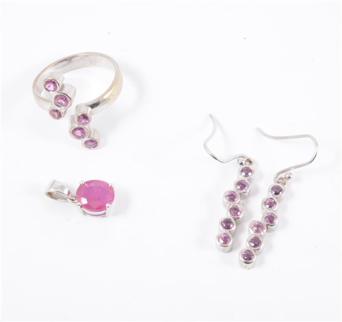 Lot 208 - An 18 carat white gold dress ring and pair of matching earrings set with pink sapphires