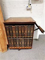 Lot 416 - Victorian oak revolving library bookcase, containing Encyclopaedia Britannica 9th Edition.