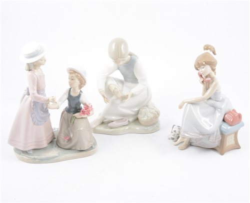 Lot 81 - A Lladro figure of a young girl on a telephone and seven other Nao figures of children (8)