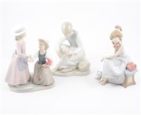 Lot 81 - A Lladro figure of a young girl on a telephone and seven other Nao figures of children (8)