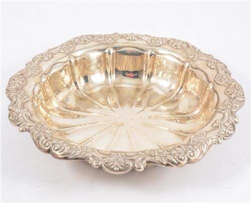 Lot 262 - A silver fluted dish with scroll and floral border, 26cm diameter, hallmarked Birmingham 1910, approximate weight 10oz.