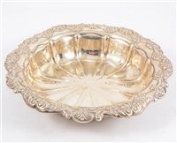 Lot 262 - A silver fluted dish with scroll and floral border, 26cm diameter, hallmarked Birmingham 1910, approximate weight 10oz.