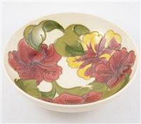 Lot 70 - A Moorcroft bowl in the "Hibiscus" design on cream ground, 26cm diameter.