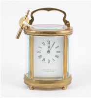 Lot 181 - A Garrrard & Co of 112 Regent St. W.1, French style brass carriage clock, oval case with oval glass panel to top revealing lever movement,15cm, complete with key.