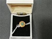 Lot 271 - A floral design turquoise dress ring with six small turquoise and a small diamond to centre, shank marked 18ct, gross weight approximately 3gms, ring size O.