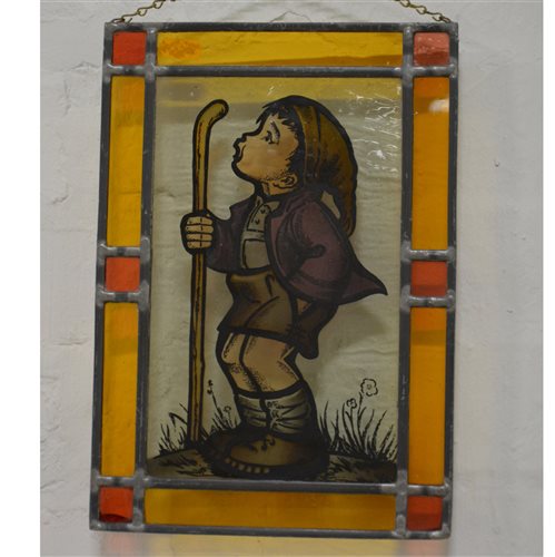 Lot 303 - Small stained glass window depicting a whistling boy
