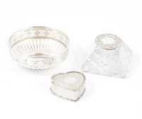 Lot 236 - Silver topped glass inkwell by Britton, Gould & Co, Birmingham 1901, heart shaped trinket box by Goldsmiths & Silversmiths Co Ltd, London 1904 and silver bon bon dish...