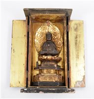 Lot 249 - A small Buddhist shrine, enclosing a figure of Buddha