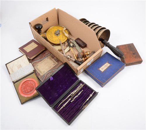 Lot 253 - A box of assorted curios, including a bell tree, pens, and boxed games