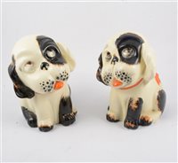 Lot 26 - Seven Crown Devon "Perky Puppy" figures, five with glass eyes, two 23cm doorstop figures, one filled with sand, 18cm, 13cm and 10cm, two with painted eyes, 22cm and  13cm. (7).
