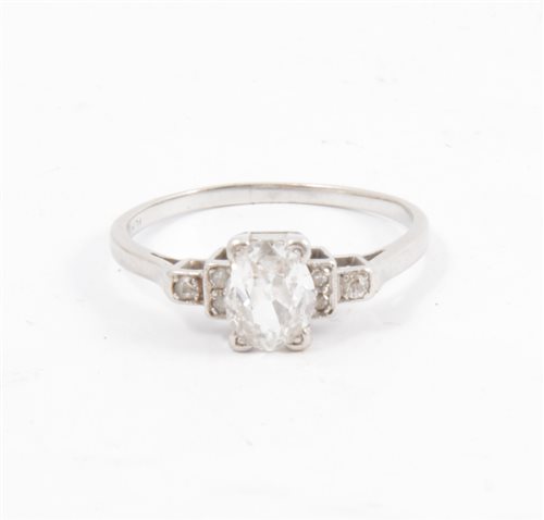 Lot 272 - A diamond solitaire ring, the oval old cut diamond four claw set with three small diamonds in each shoulder