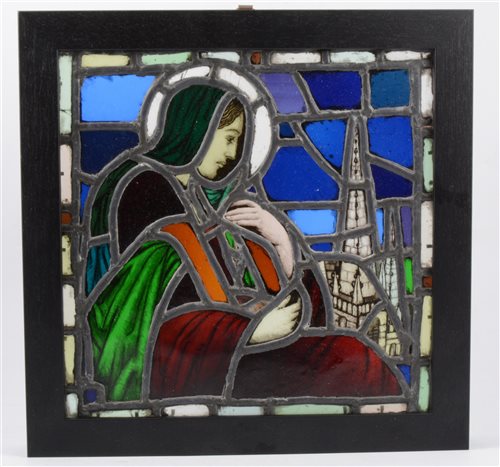 Lot 227 - A stained glass panel of the Madonna and a church steeple originally from a a demolished church in Exeter, 31cm square in a black frame overall 38cm square.
