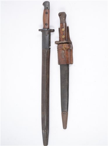 Lot 141 - wo Bayonets, one marked Wilkinson 1907 with two piece wooden grip in a steel mounted leather sheath 57cm, another later bayonet marked ER