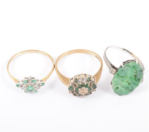 Lot 248 - Two diamond and emerald rings in 9 carat yellow and white gold, ring sizes T, and a carved jade ring in an all white metal ring marked 585, ring size P.