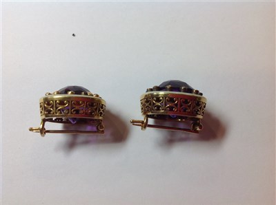 Lot 264 - A pair of Fabergé amethyst and diamond lapel brooches