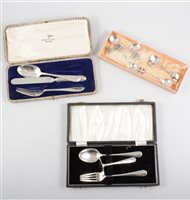 Lot 287 - A tray of silver flatware to include a cased christening silver spoon, fork and pusher set, another walker & Hall set with knife, fork and spoon