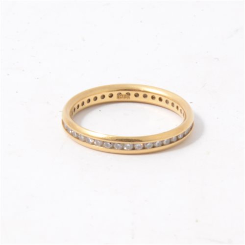 Lot 185 - A diamond full eternity ring, the brilliant cut stones, channel set in an all yellow metal full eternity mount 2.8mm wide, marked 18ct, ring size L.