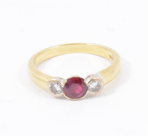Lot 190 - A ruby and diamond three stone ring, a circular ruby and two brilliant cut diamonds collet set in an 18 carat yellow and white gold mount, hallmarked Birmingham 1996, ring size M.