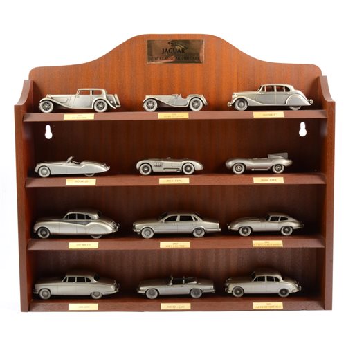 Lot 289 - Danbury Mint Jaguar The Classic Motor Car pewter cast models, three wooden wall shelf units of models, and a small selection of Mark Models silver-plated models, 32 models in total.