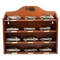 Lot 289 - Danbury Mint Jaguar The Classic Motor Car pewter cast models, three wooden wall shelf units of models, and a small selection of Mark Models silver-plated models, 32 models in total.