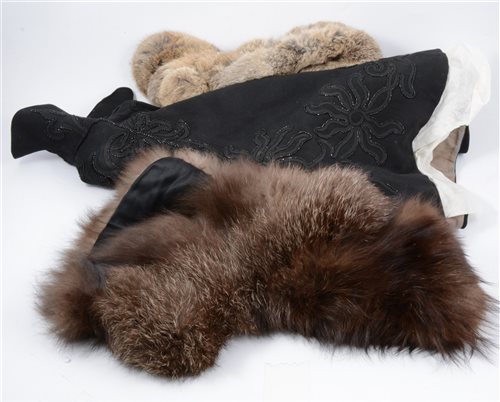 Lot 170 - A collection of vintage costumes, including fur collars and cuffs, a Victorian wool and beaded black mourning cape, a black beaded lace mourning cape, a Japanese red quilted jacket... (1 box)