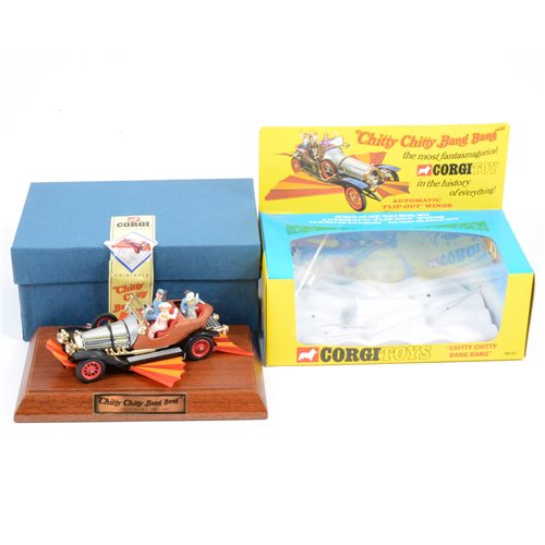Lot 128 - Corgi Toys Chitty Chitty Bang Bang with automatic flip-out wings diecast model, a reproduction of the 1960s model, boxed with wooden plinth.