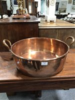 Lot 373 - A large copper twin handled pan, 46cm diameter, 16cm deep.
