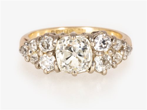 173 - A diamond half hoop ring, a old cushion cut diamond claw set to centre with five smaller old cut diamonds to each side