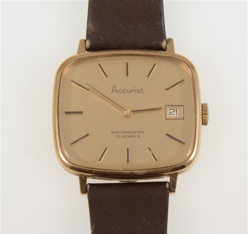 Lot 320 - Accurist - a gentleman's 21 Jewel Shockmaster wrist watch, TV shape champagne baton dial with date aperture in a 9 carat yellow gold case, strap model