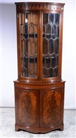 Lot 350 - Reproduction mahogany freestanding corner cupboard, cylinder front, two astragal glazed panelled doors to the upper section, two further doors below, width 80cm, height 192cm