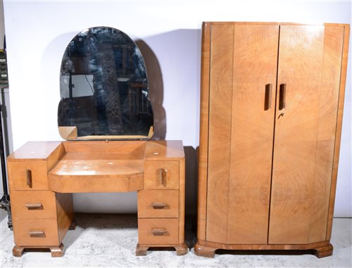 Lot 349 - Art Deco style walnut four-piece bedroom suite, comprising a dressing table, frieze drawer with three drawers to each pedestal, width 117cm; double wardrobe; a compactum; and a bedstead, (4)