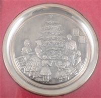 Lot 186 - Silver Christmas plate, moulded and framed, embossed with a scene of a Victorian family round a tree, diameter 19cm, cased