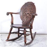 Lot 392 - American walnut rocking chair, oval carved back, shaped arms, turned legs, 66cm.