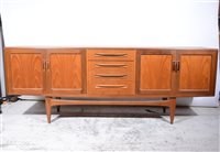 Lot 419 - G-Plan teak sideboard, fitted with drawers and cupboards, length 214cm, depth 47cm, height 80cm. and a nest of three teak tables, (4).