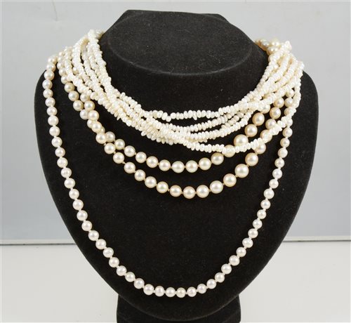 Lot 308 - A collection of pearl necklaces, a five row freshwater pearl necklace, a single row cultured pearl necklace with eighty 6mm pearls knotted every pearl into a necklace 55cm long