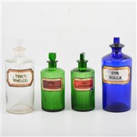 Lot 63 - A collection of pharmaceutical jars with labels.