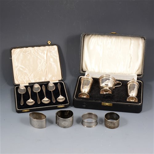 Lot 185 - A boxed silver three piece condiment set by Viner's Ltd, Sheffield 1959 and 1960; a cased set of six teaspoons by William Suckling Ltd, Birmingham 1934; three silver napkin rings. (6)