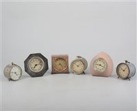 Lot 147 - A small Continental metal cased table clock, enamelled case, 7.5cm and five other small timepieces, (6).