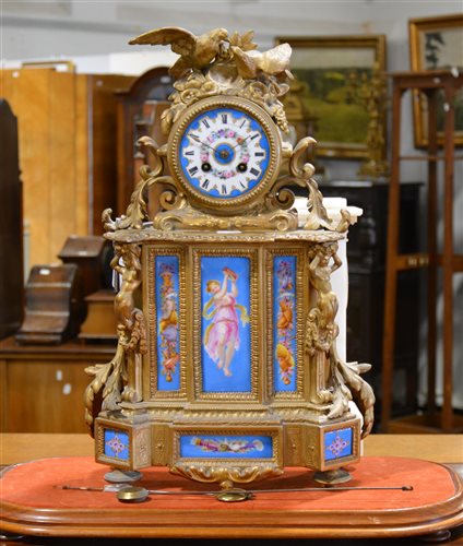 Lot 136 - Large French gilt spelter mantel clock, the case inset with blue ground porcelain panels, circular dial (damaged), cylinder movement striking on a bell, 50cm, on a walnut framed plinth.