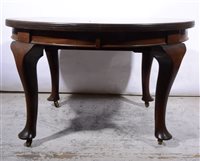 Lot 405 - Edwardian walnut wind-out dining table, oval top with two leaves., cabriole legs, maximum length 203cms.