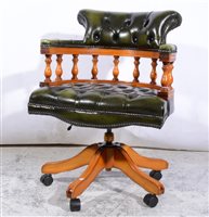 Lot 423 - Modern beech revolving Captain's chair, buttoned leather upholstery, width 63cm.