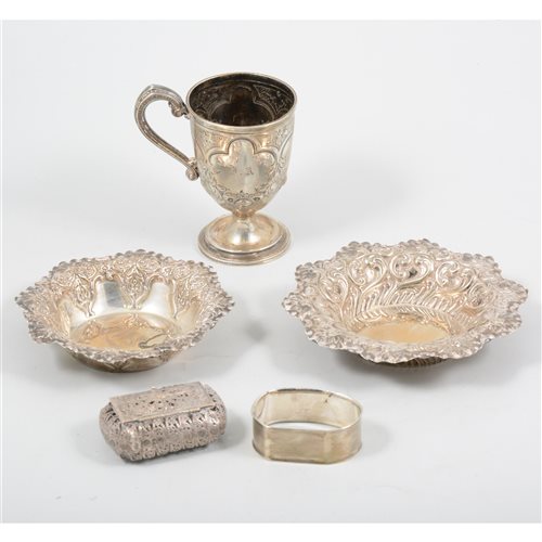 Lot 182 - Two silver repousse dishes, Sheffield 1895 and 1896 a Victorian silver christening mug Birmingham 1868, an engine turned napkin ring