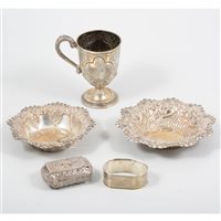Lot 182 - Two silver repousse dishes, Sheffield 1895 and 1896 a Victorian silver christening mug Birmingham 1868, an engine turned napkin ring