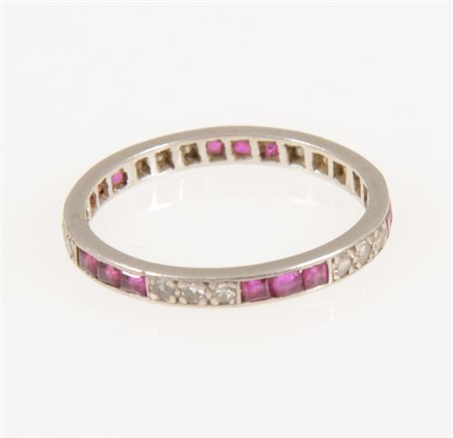 Lot 219 - A ruby and diamond full eternity ring, alternating groups of three square cut rubies and eight cut diamonds, fifteen rubies and sixteen diamonds in total