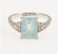Lot 216 - An aquamarine and diamond ring, the rectangular mixed cut stone, 9.8mm x 7.4mm, four claw set with three small diamonds set to each side