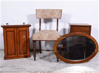 Lot 383 - Small oak wall cabinet, oak sewing table, oak dining chair and a walnut framed oval wall mirror, (4).