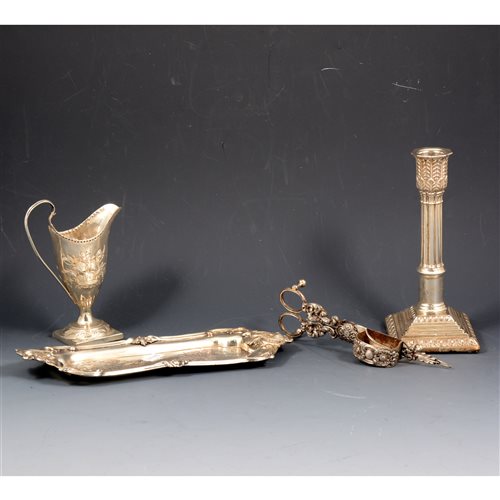 Lot 176 - A silver helmet-shaped cream jug, floral decoration with a vacant cartouche, London 1903, 14cm high, approx. 2.7oz; a silver Corinthian column-style candlestick, Birmingham 1898, 18cm high (4)