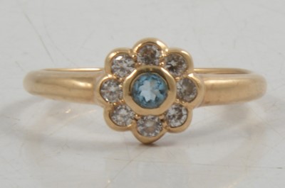 Lot 265 - A synthetic stone and cubic zirconia daisy cluster ring.