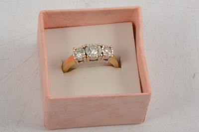 Lot 251 - A three stone diamond ring.