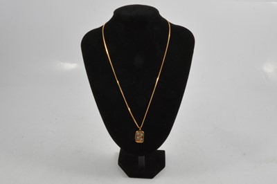 Lot 293 - A small 9 carat yellow and white gold locket on a 9 carat yellow gold chain.